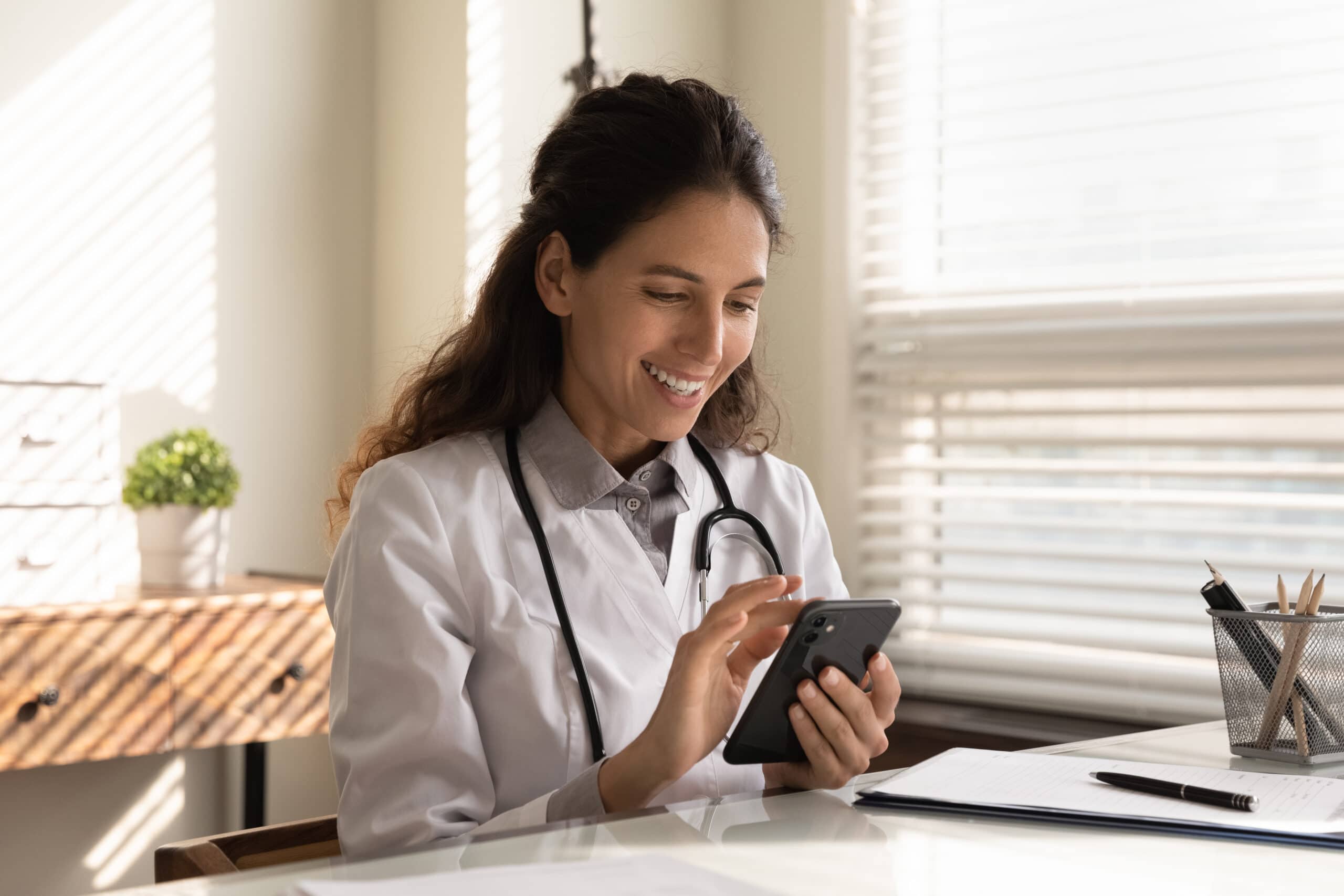 Smiling,Young,Caucasian,Female,Doctor,In,White,Medical,Uniform,Sit Gary Behler